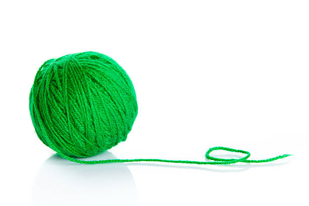 istock Green wool yarn ball isolated on white  background 475986847