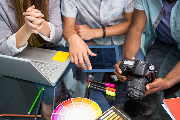 istock Close up of creative business people with digital camera 475987196