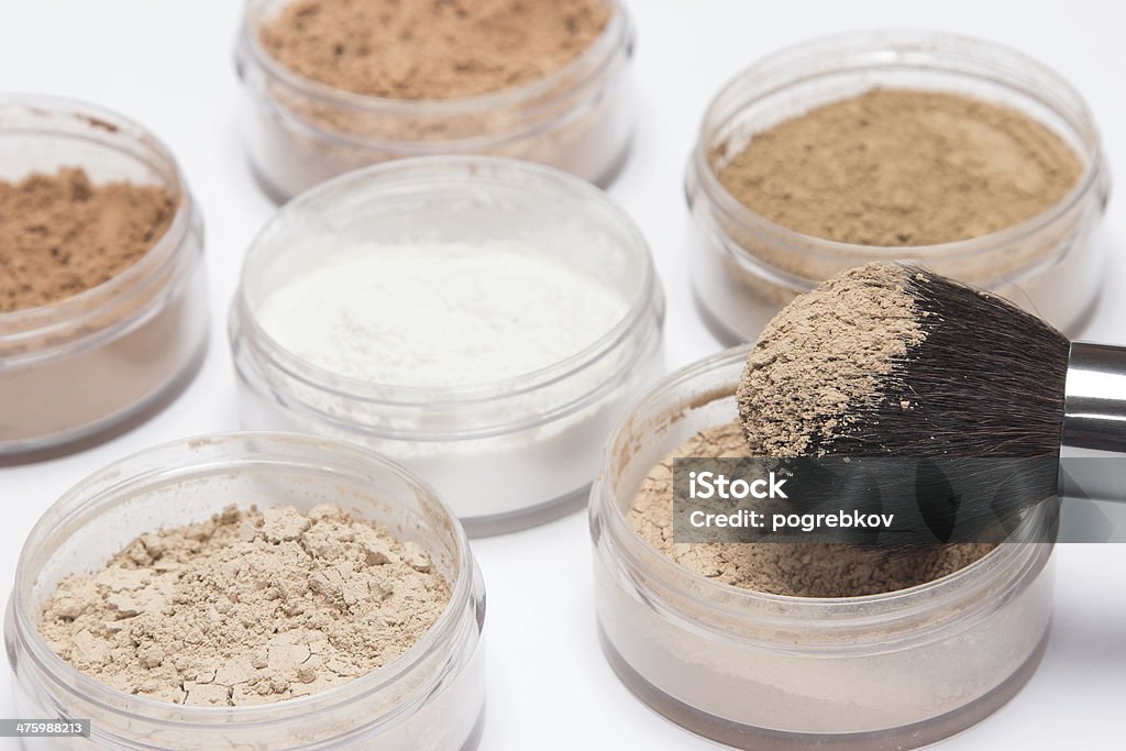 Makeup brush with loose cosmetic powder Makeup brush against the background of jars with loose cosmetic powder Beautician Stock Photo