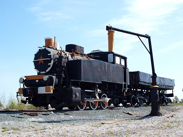 istock Old soviet locomotive on a background of blue sky 475988312