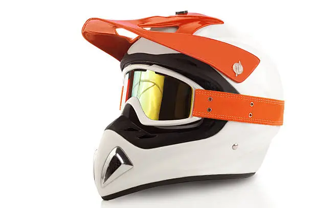 Orange motorcycle glasses and  helmet isolated on white