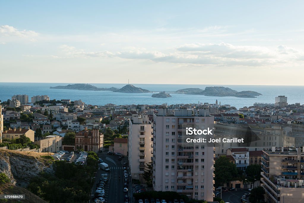 Chateau d'If in Marseille, France View of buildings and the Mediterranean Sea in Marseille, France. The small island in the center is Chateau d'If, which featured in Alexandre Dumas' novel The Count of Monte Cristo. 2015 Stock Photo
