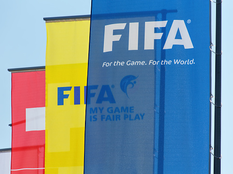 Zurich, Switzerland - 3 June, 2015: flags at the entrance of the FIFA headquarter. FIFA (International Federation of Association Football) is the international governing body of association football (soccer), futsal and beach soccer. FIFA is responsible for the organisation of football's major international tournaments.