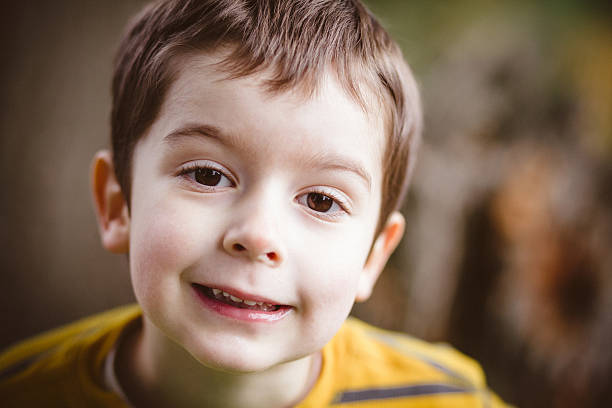 istock Boy plays with toy cars outside 475991332