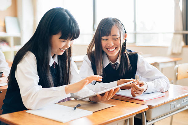 istock Japanese School Girls Using digital Tablet in Classroom 475991656