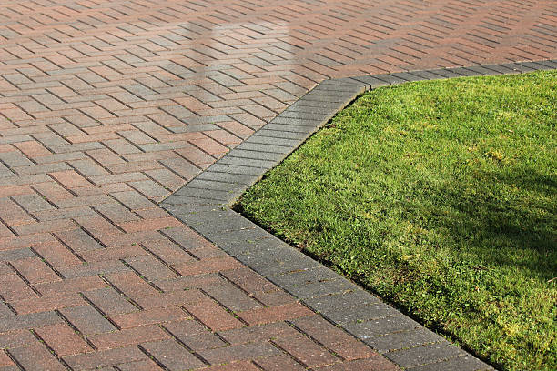 istock Image of red brick / block-paved driveway next to front lawn 475991940