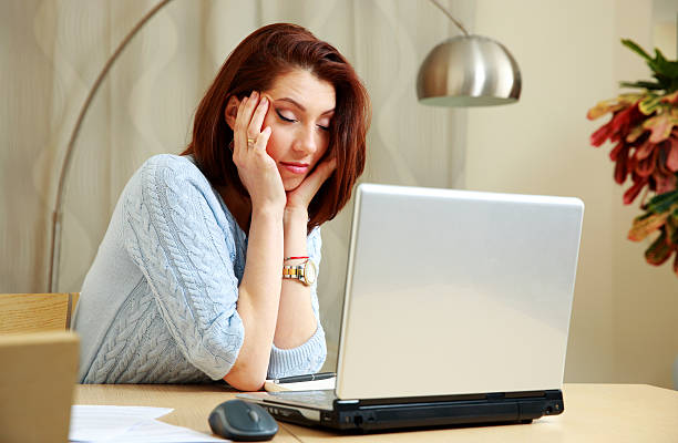 istock Tired woman with closing eyes sitting on her workout 475992307