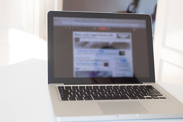 istock Laptop in an empty and natural lit room. 475992434