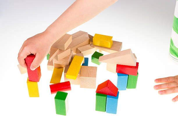 istock Child's hand and building blocks 475995792
