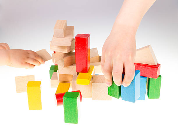 istock Child's hand and building blocks 475995868
