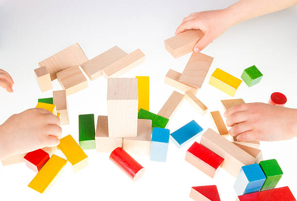 istock Child's hand and building blocks 475997842