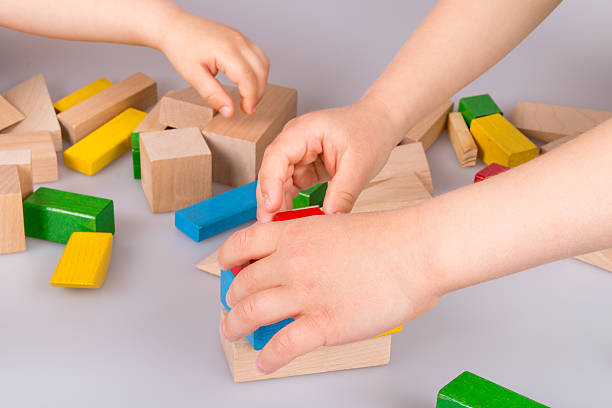 istock Child's hand and building blocks 475997854