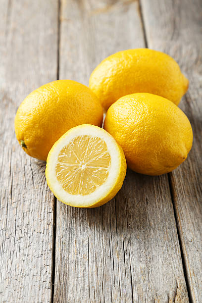 istock Lemons on grey wooden background 475997942