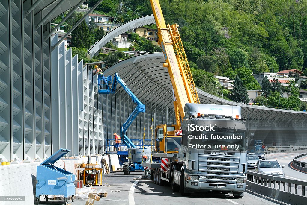 Workers during the installation of noise barriers on the highway Bissone, Switzerland - 20 May 2010: Workers during the installation of noise barriers on the highway at Bissone on Switzerland Multiple Lane Highway Stock Photo