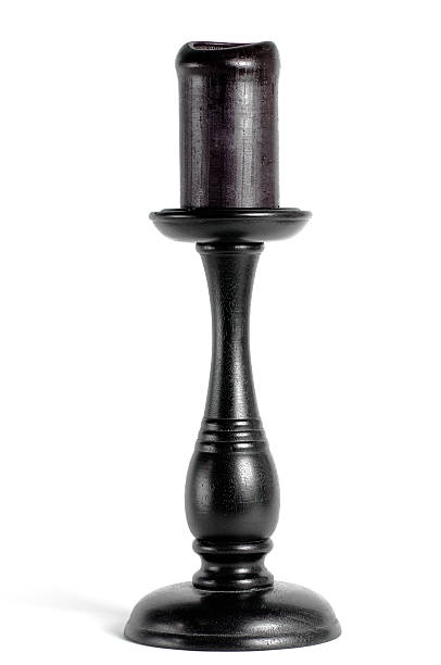 Wooden black candleholder with black candle on white stock photo