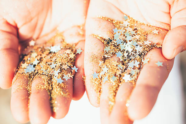 istock woman hands and glitter and stars 476004140