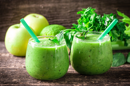 green Detox smoothie on wooden table