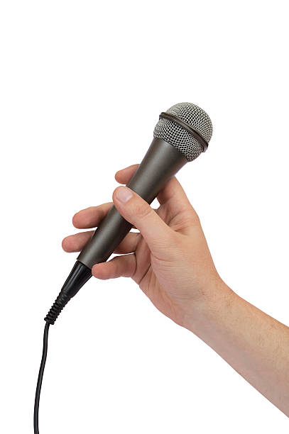 istock male hand holding a microphone 476005400