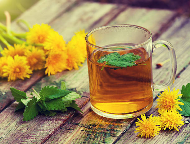 istock The cup of melissa herbal tea on a wooden table 476007836