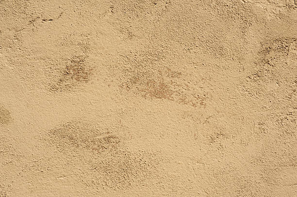 istock Texture of old wall covered with yellow stucco 476009050