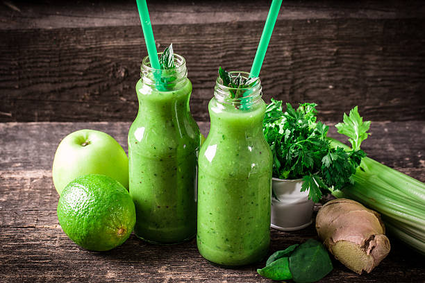 istock green Detox smoothie on wooden table 476009416