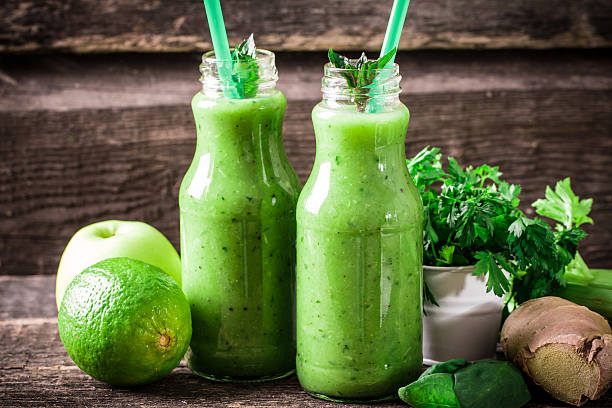 istock green Detox smoothie on wooden table 476009436