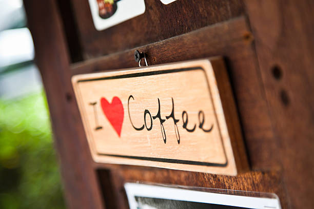 A Generic 'I Love Coffee' sign hanging on the door of an old style Cafe in Pai Thailand.