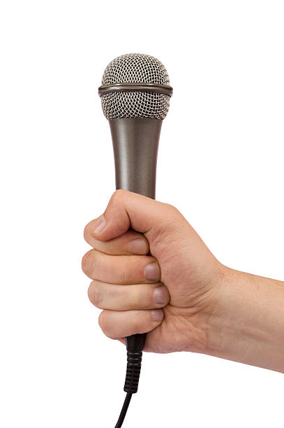 istock male hand holding a microphone 476010174
