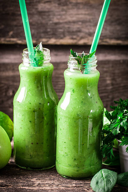 istock green Detox smoothie on wooden table 476010368