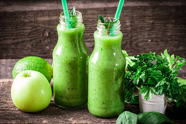istock green Detox smoothie on wooden table 476010370