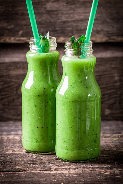 istock green Detox smoothie on wooden table 476010382