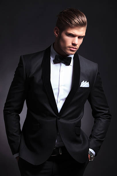 istock business man on black with hands in pockets 476010445