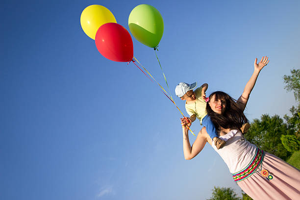 istock Mother and son playing with balloons 476011267