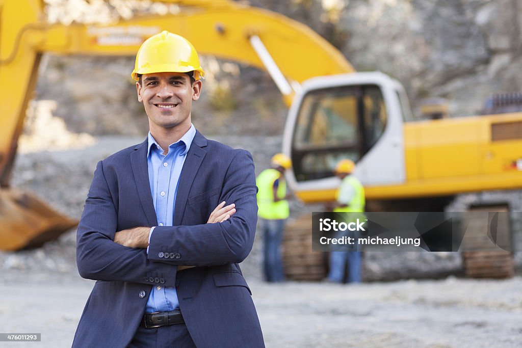 mine manager with arms crossed cheerful manager with arms crossed Construction Site Stock Photo