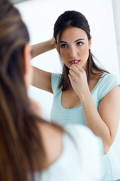 istock Young beautiful woman making hairstyle near mirror. 476013030