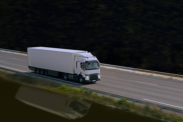 white semi truck on highway stock photo