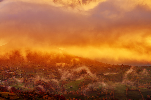 nature and it's beauty, autumn sunset over hill and dramatic clouds.