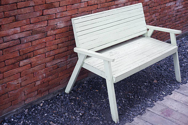 istock wooden chair on brick wall 476013682