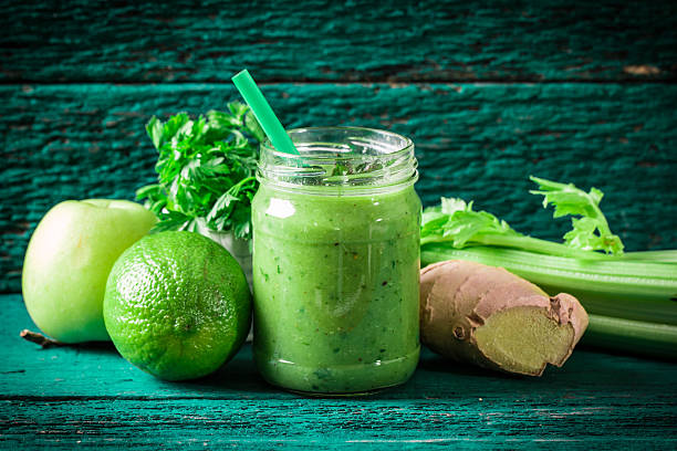 istock green Detox smoothie on wooden table 476014606
