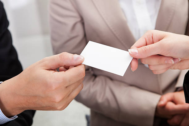 istock Businesspeople exchanging cards over coffee 476021266