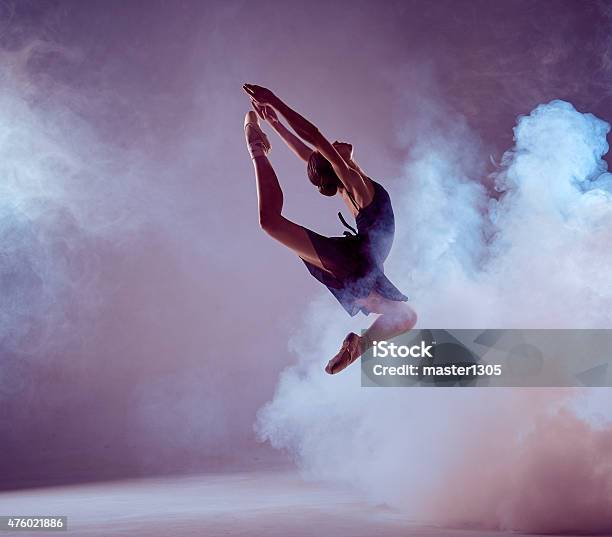 Beautiful Young Ballet Dancer Jumping On A Lilac Background Stock Photo - Download Image Now