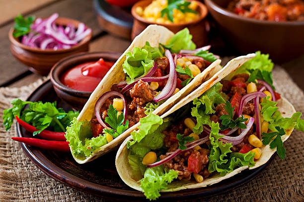 istock Mexican tacos with meat, vegetables and red onion 476021932