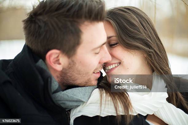 Young Couple Being Affectionate In Winter Stock Photo - Download Image Now - Couple - Relationship, Pregnant, Snow