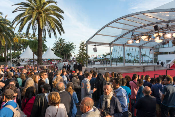 Cannes Film Festival Cannes, France - May 24, 2014: Great Auditorium of the exit door at Cannes in France, the famous red carpeted stairs and crowd of people waiting at the gate output. cannes film festival stock pictures, royalty-free photos & images