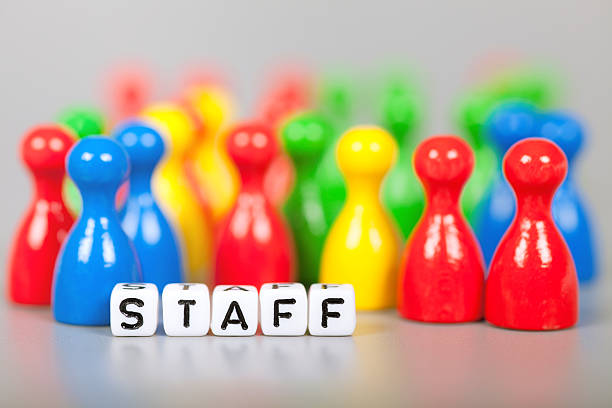 istock Cube Letters show staff  in front of unsharp ludo figures 476025870