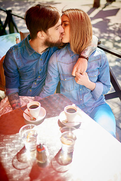 istock Kissing at sidewalk cafe 476026980