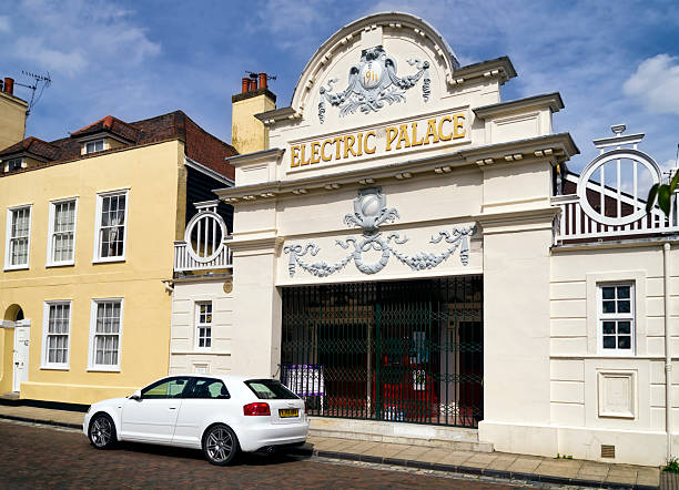 Harwich, Essex, England - May 11, 2015: A white Audi car parked outside the Electric Palace cinema in Harwich, Essex, England. The Electric Palace opened in 1911 and is still in regular use as a cinema as well as hosting concerts and other events.