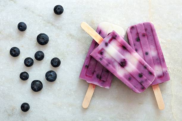 istock Blueberry vanilla ice pops on white marble 476028444