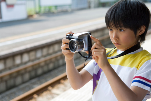 Boy holding camera on the platform