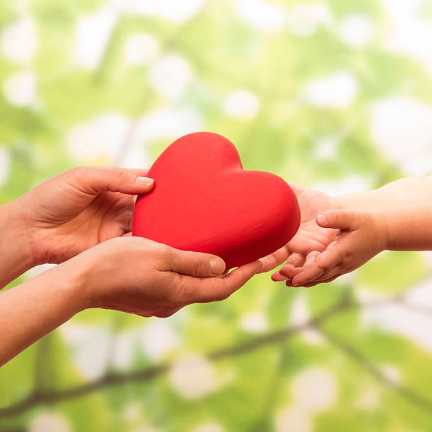 istock Man and child holding heart 476028996